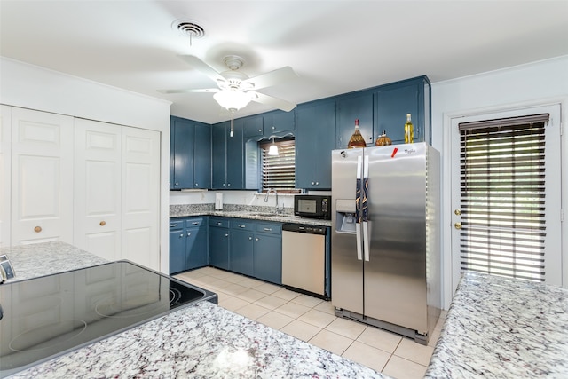 kitchen with dishwashing machine, ceiling fan, blue cabinetry, stainless steel fridge, and light tile patterned floors