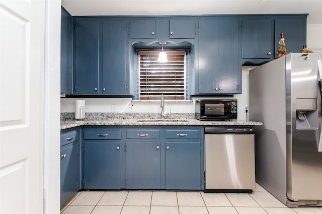 kitchen with sink, blue cabinets, stainless steel appliances, and light tile patterned floors