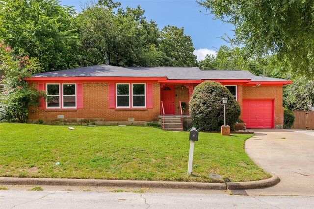 single story home featuring a garage and a front yard