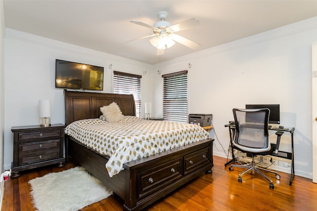 bedroom featuring hardwood / wood-style flooring, crown molding, and ceiling fan