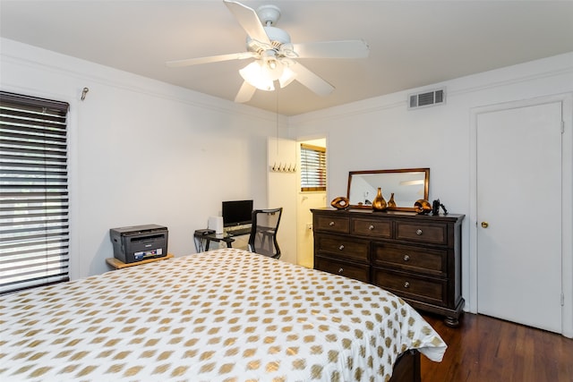 bedroom with multiple windows, ceiling fan, dark hardwood / wood-style floors, and crown molding