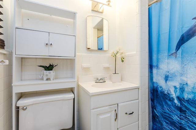 bathroom featuring vanity, toilet, backsplash, and tile walls