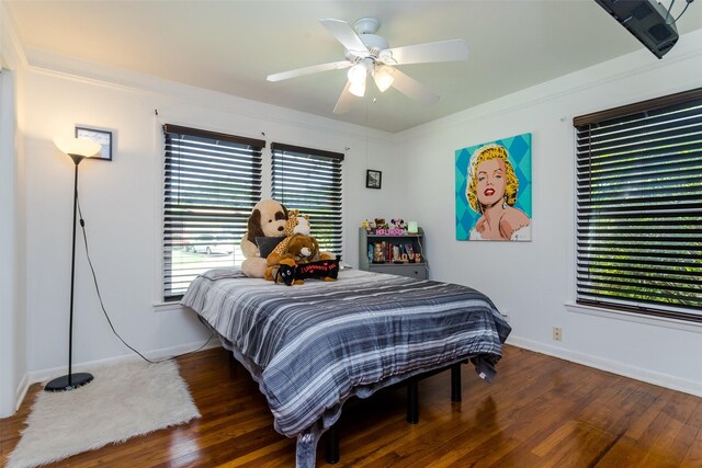 bedroom with ornamental molding, hardwood / wood-style floors, and ceiling fan