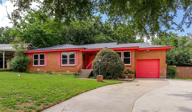 ranch-style house featuring a garage and a front yard