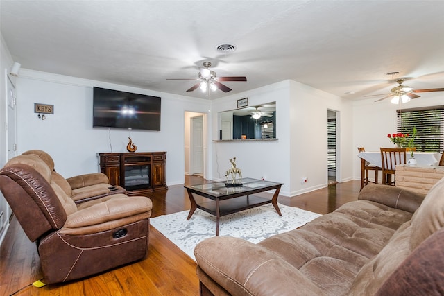 living room with dark hardwood / wood-style floors and ceiling fan