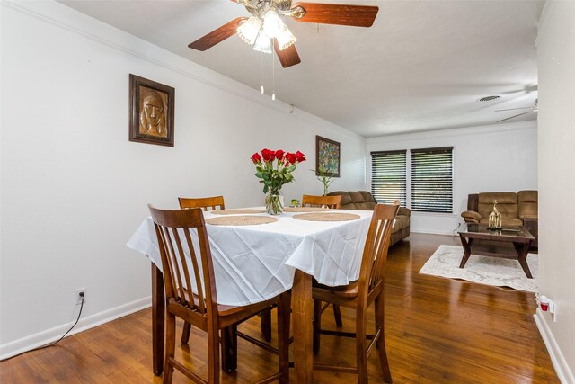 dining space featuring crown molding, dark hardwood / wood-style floors, and ceiling fan