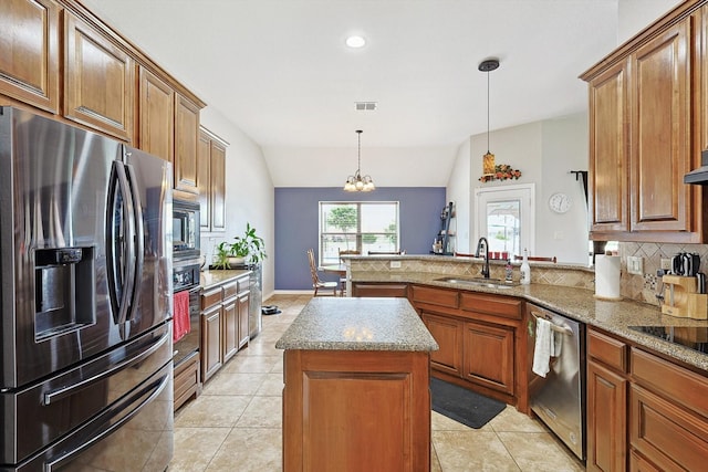 kitchen featuring sink, a center island, kitchen peninsula, stainless steel appliances, and backsplash