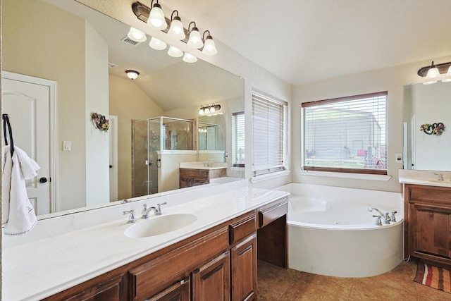 bathroom with tile patterned floors, vanity, shower with separate bathtub, and lofted ceiling