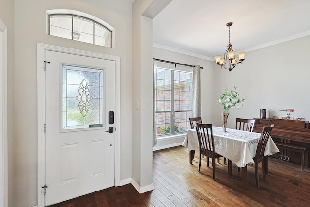 interior space featuring ornamental molding, an inviting chandelier, and dark hardwood / wood-style floors