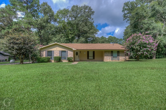 ranch-style home featuring a front yard