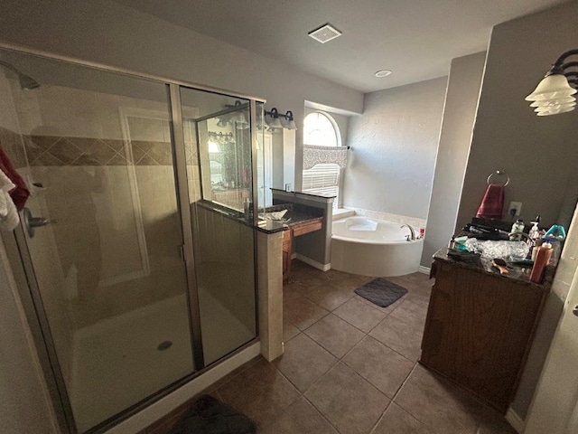 bathroom featuring vanity, independent shower and bath, and tile patterned flooring