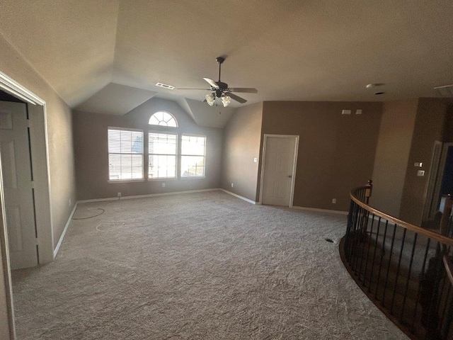 unfurnished living room with vaulted ceiling, light carpet, and ceiling fan