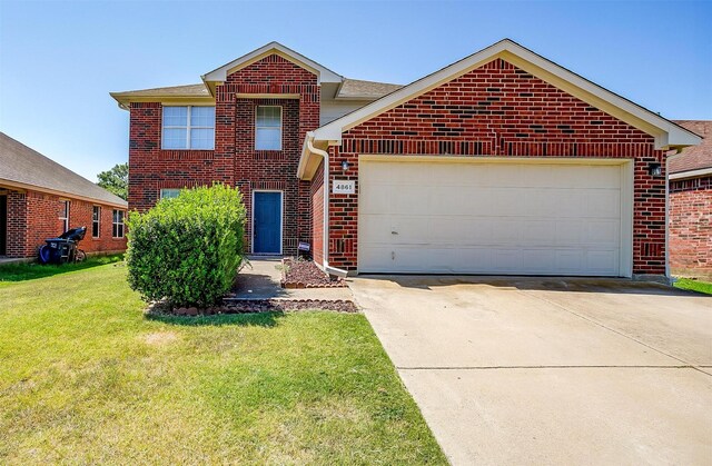 front of property featuring a front lawn and a garage