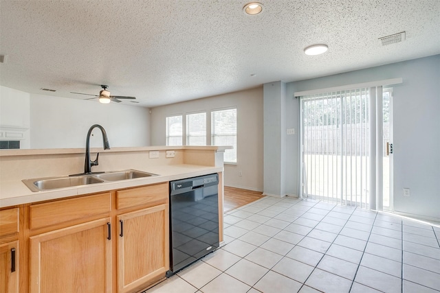 kitchen with black dishwasher, sink, light tile patterned floors, a textured ceiling, and ceiling fan