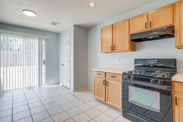 kitchen featuring a textured ceiling, light brown cabinets, light tile patterned floors, and black gas range oven