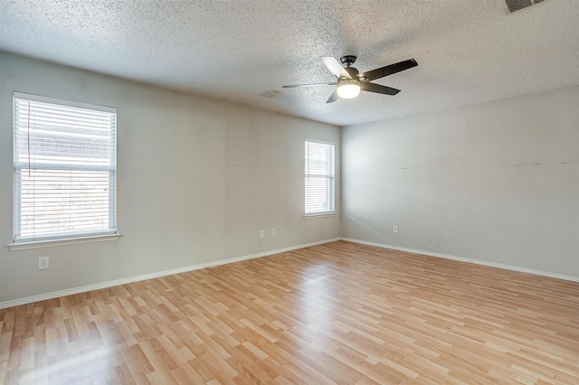 unfurnished room featuring ceiling fan, a textured ceiling, and light hardwood / wood-style flooring