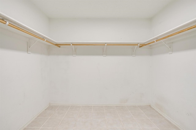 spacious closet with light tile patterned floors