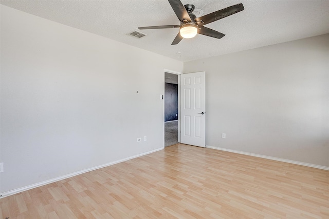 unfurnished room with light hardwood / wood-style floors, ceiling fan, and a textured ceiling