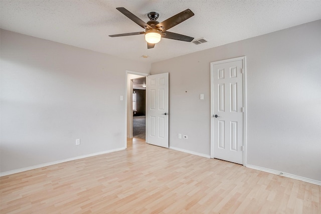 unfurnished bedroom with light hardwood / wood-style floors, ceiling fan, and a textured ceiling