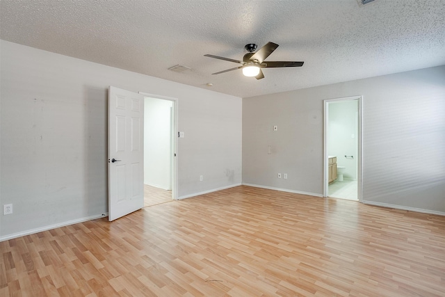 empty room featuring a textured ceiling, light hardwood / wood-style flooring, and ceiling fan