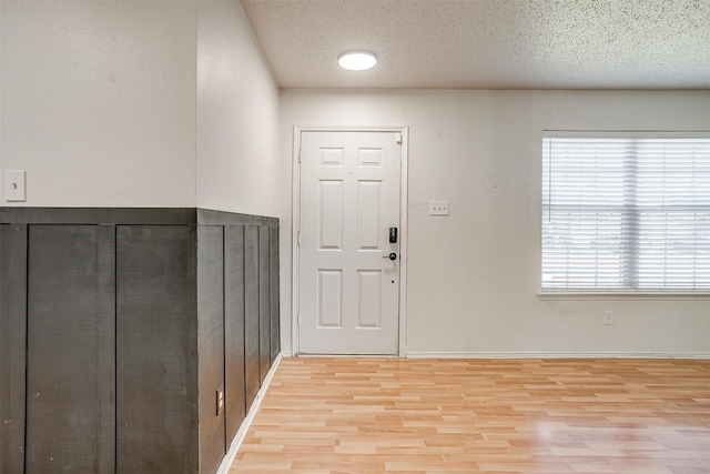 entrance foyer featuring a textured ceiling and light hardwood / wood-style flooring