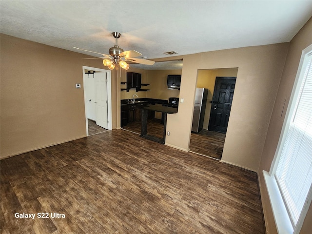 kitchen with stainless steel refrigerator, ceiling fan, dark hardwood / wood-style floors, and sink