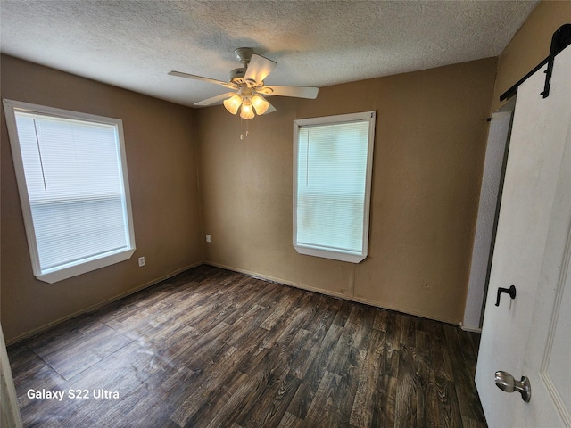 spare room with ceiling fan, dark hardwood / wood-style flooring, and a textured ceiling