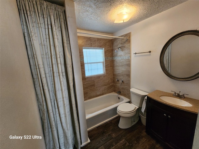 full bathroom with shower / bath combo, hardwood / wood-style floors, vanity, a textured ceiling, and toilet