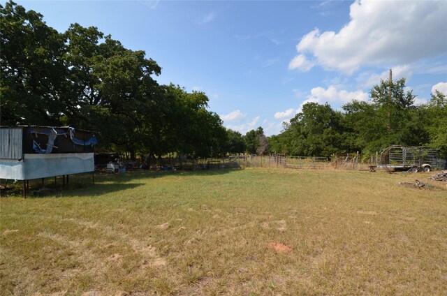 view of yard with a rural view