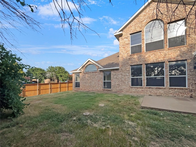 rear view of property featuring a yard