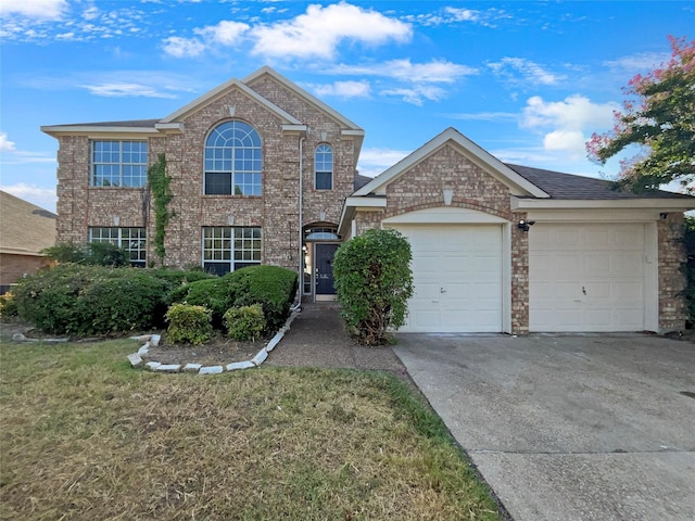 view of front facade with a garage and a front yard