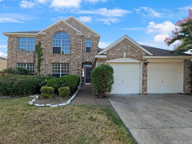 view of front of property with a garage and a front yard