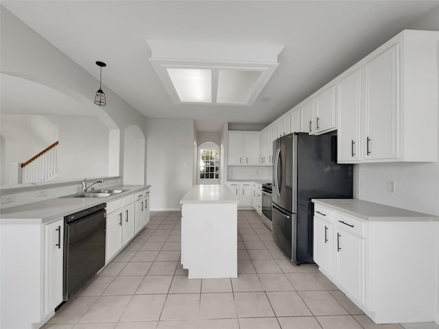 kitchen featuring sink, white cabinetry, hanging light fixtures, stainless steel appliances, and light tile patterned flooring