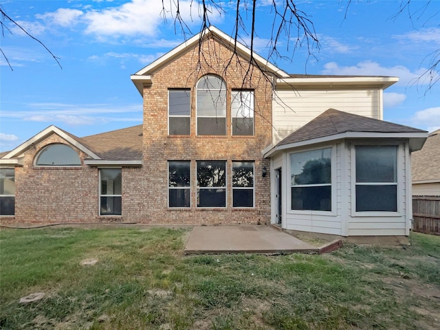 rear view of property with a yard and a patio area