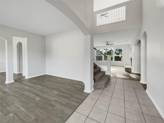 foyer entrance with ceiling fan and tile patterned floors