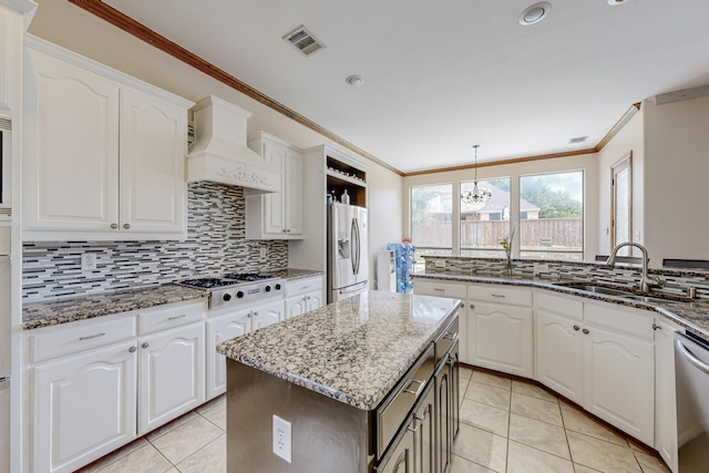 kitchen with white cabinetry, sink, white appliances, and a center island