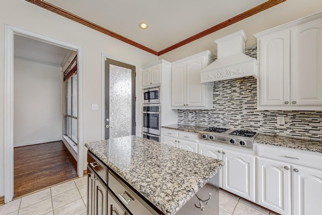 kitchen featuring custom exhaust hood and white cabinets