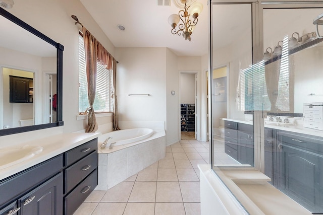 bathroom with a chandelier, tile patterned floors, independent shower and bath, and vanity