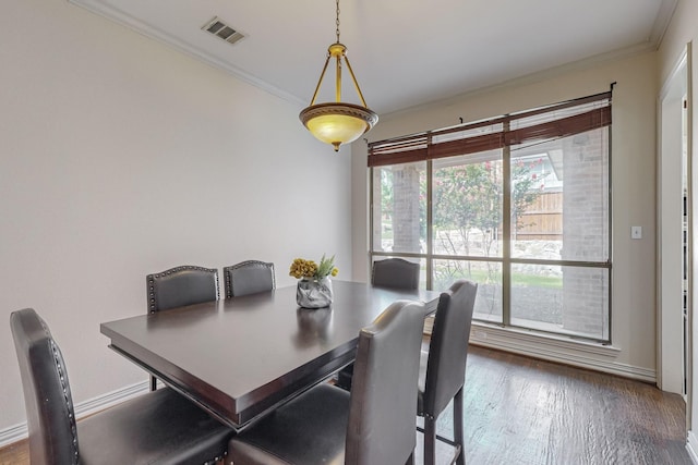 dining area featuring ornamental molding and wood-type flooring