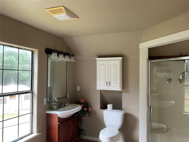 bathroom with vaulted ceiling, vanity, walk in shower, and toilet