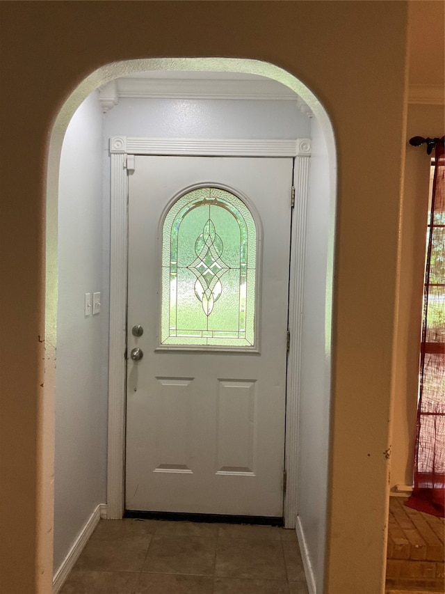 doorway to outside featuring tile patterned flooring