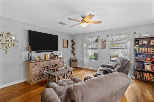 living room featuring hardwood / wood-style flooring and ceiling fan