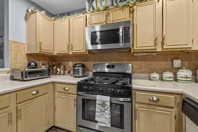 kitchen featuring light brown cabinets, tasteful backsplash, and stainless steel appliances