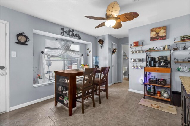 dining room with tile patterned flooring and ceiling fan