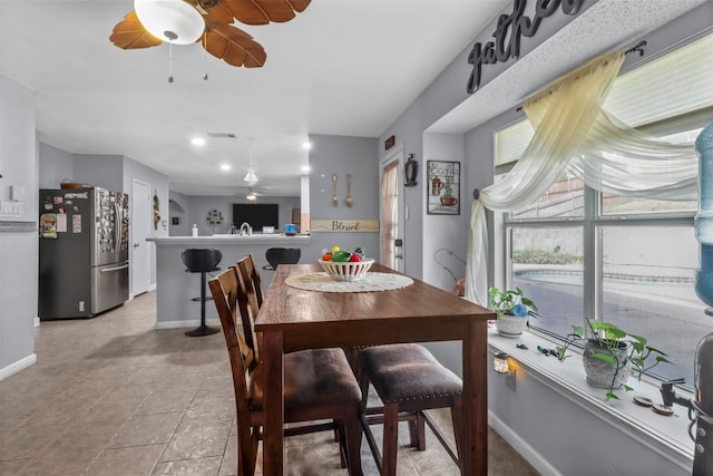 dining room with ceiling fan and light tile patterned floors