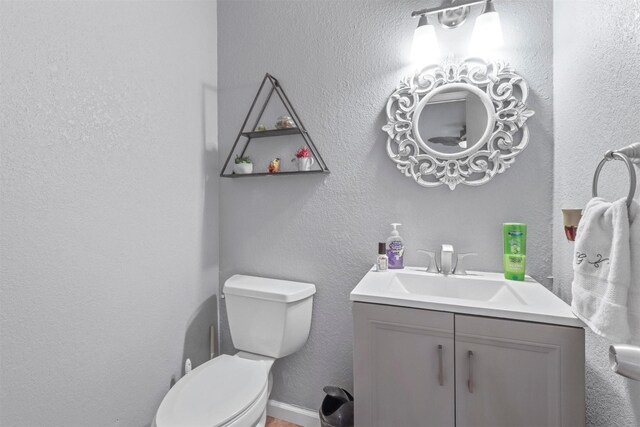 bathroom featuring toilet and vanity