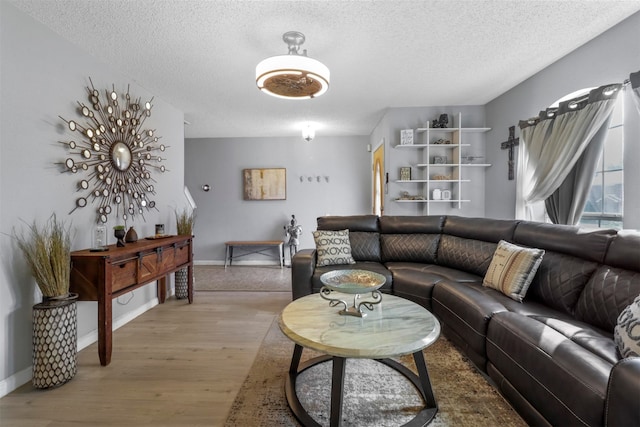 living room featuring a textured ceiling and hardwood / wood-style floors