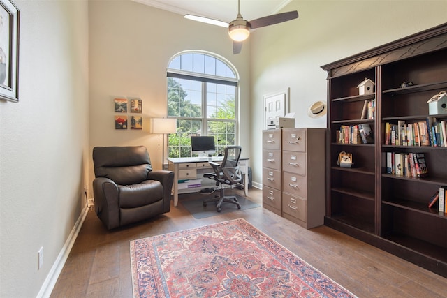 home office featuring crown molding, ceiling fan, and hardwood / wood-style flooring