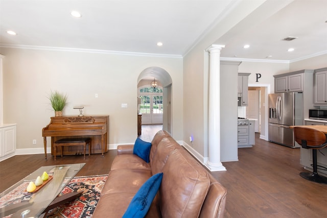 living room featuring ornamental molding, dark wood-type flooring, and ornate columns