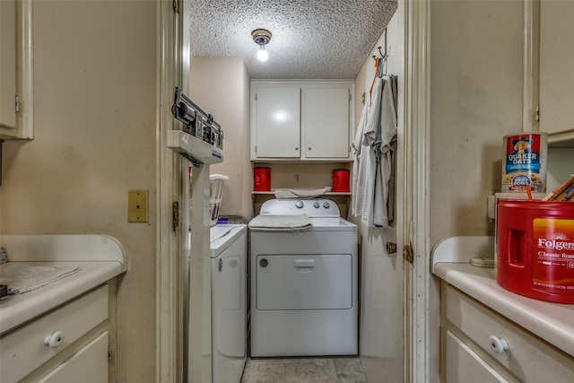 laundry room with independent washer and dryer, a textured ceiling, and cabinets